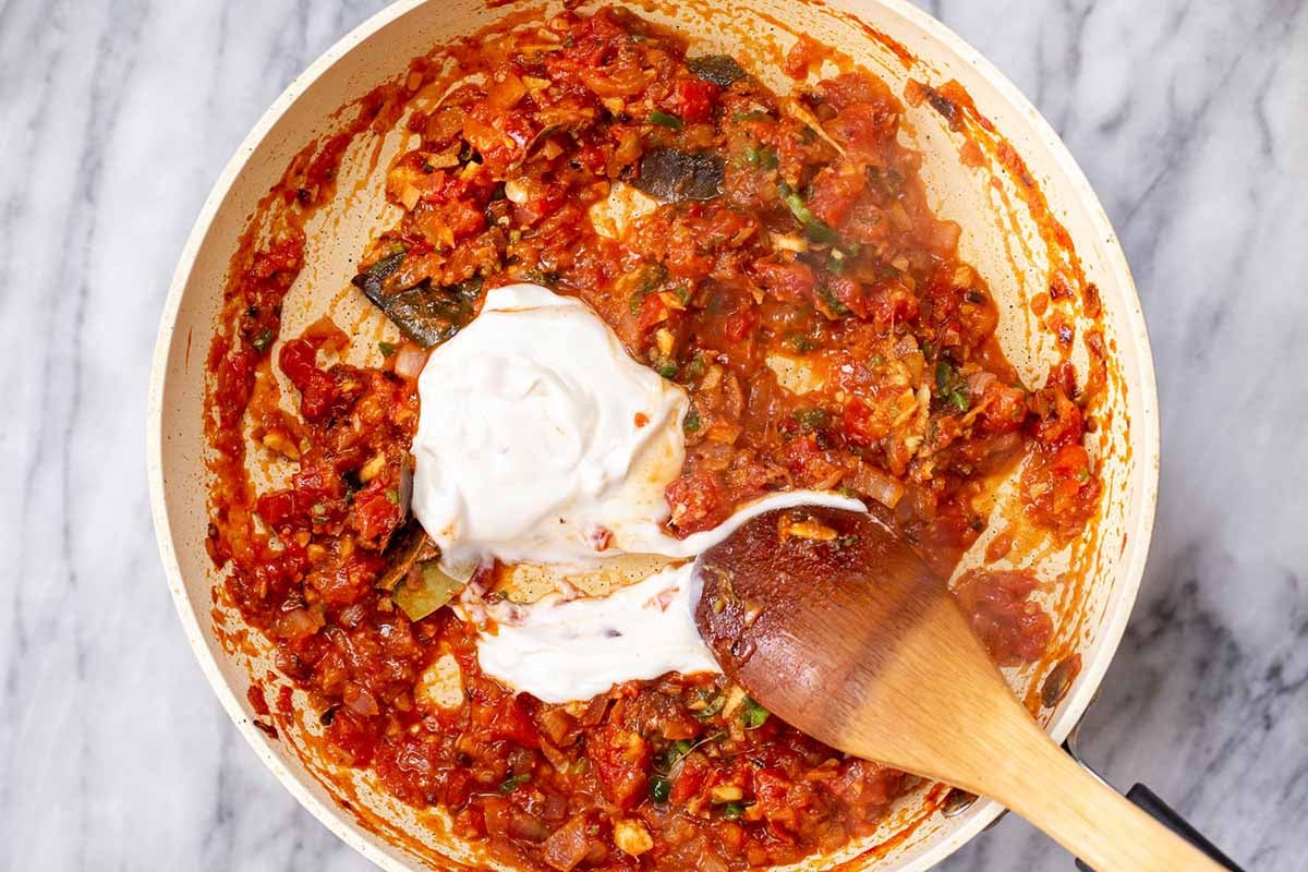 adding non-dairy yogurt to the tomato-ginger mixture