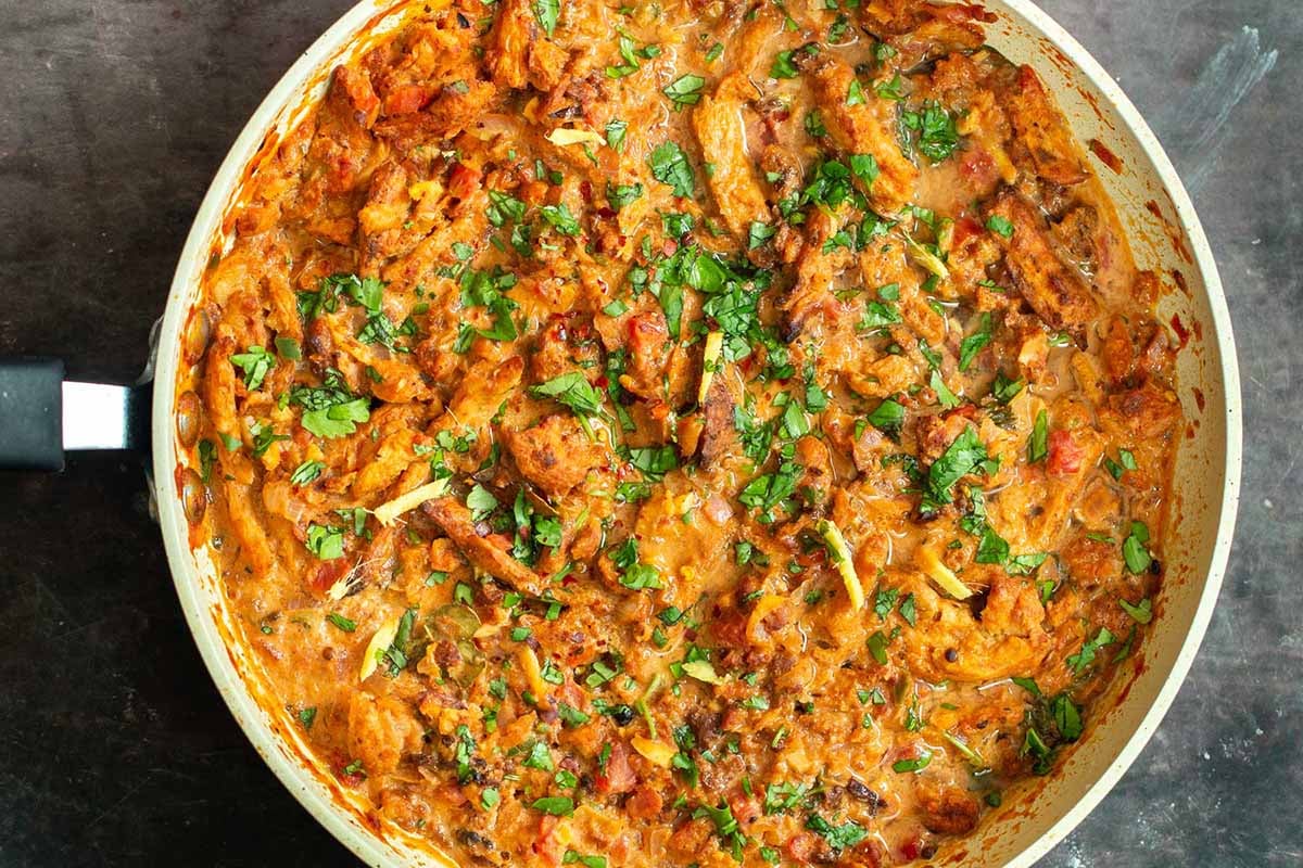Adraki ginger curry soy curls in the pan with cilantro and fresh ginger on top