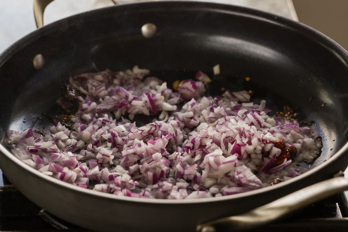 adding onions to the pan