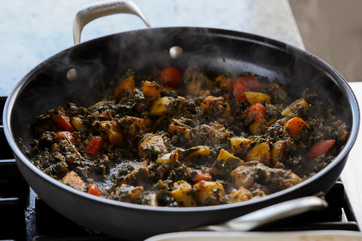 saag aloo in the pan after mixing in the potatoes