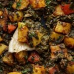 close-up of saag aloo in the pan with a piece of flatbread
