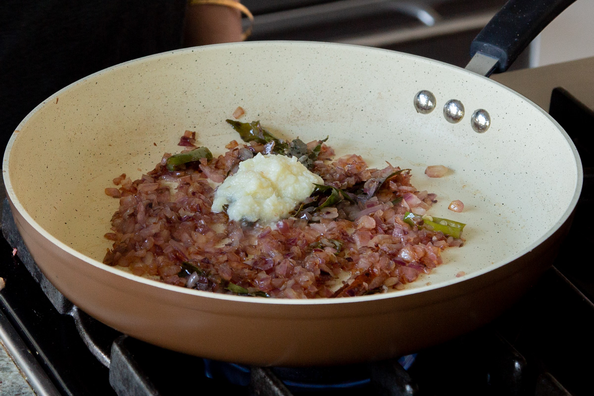 adding ginger-garlic paste to the pan