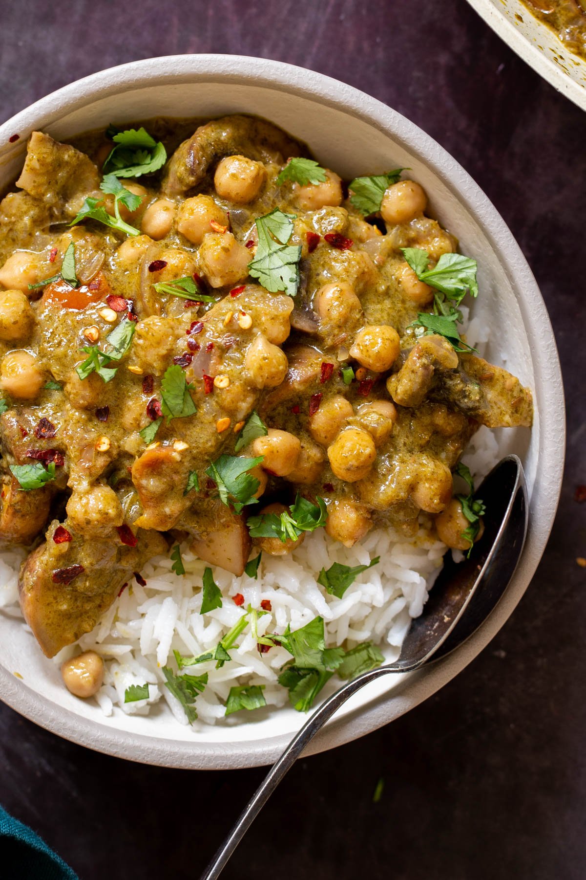 close-up of Andhra green chili chickpeas in a bowl with rice and cilantro