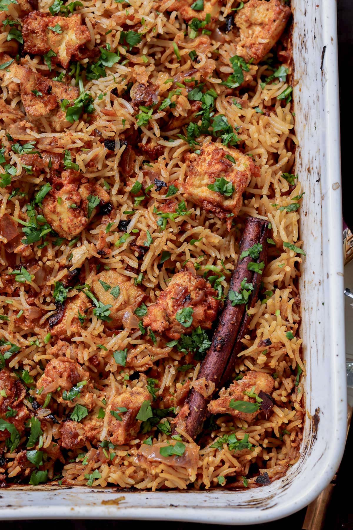 close-up of baked Lucknowi biryani in the pan