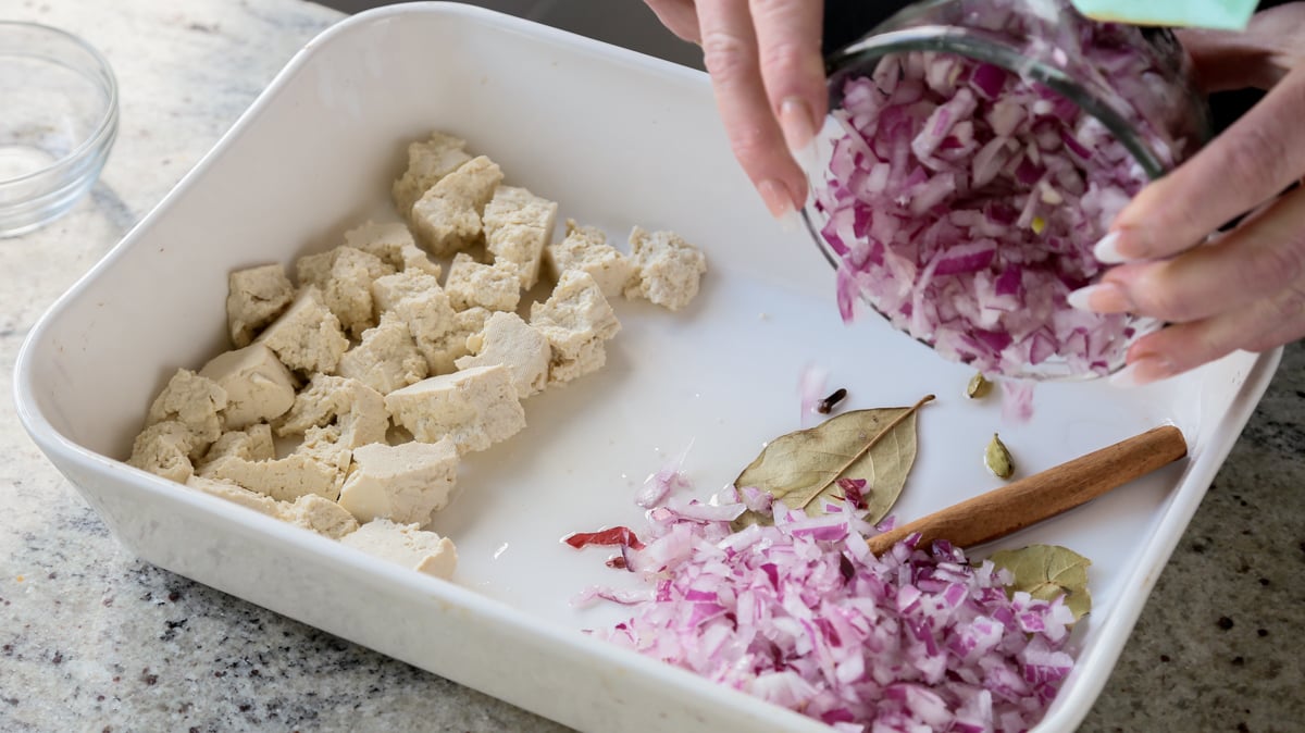 adding onion to the other side of the baking pan