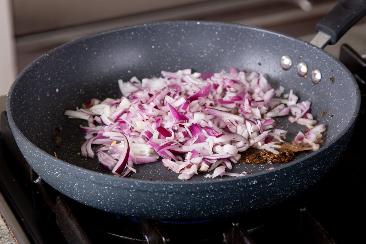 adding onion to the pan