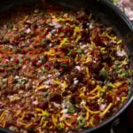 cooked beans in the pan after adding toppings