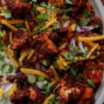close-up of tofu chorizo burrito bowl with rice, pico de Gallo, and vegan cheese on top