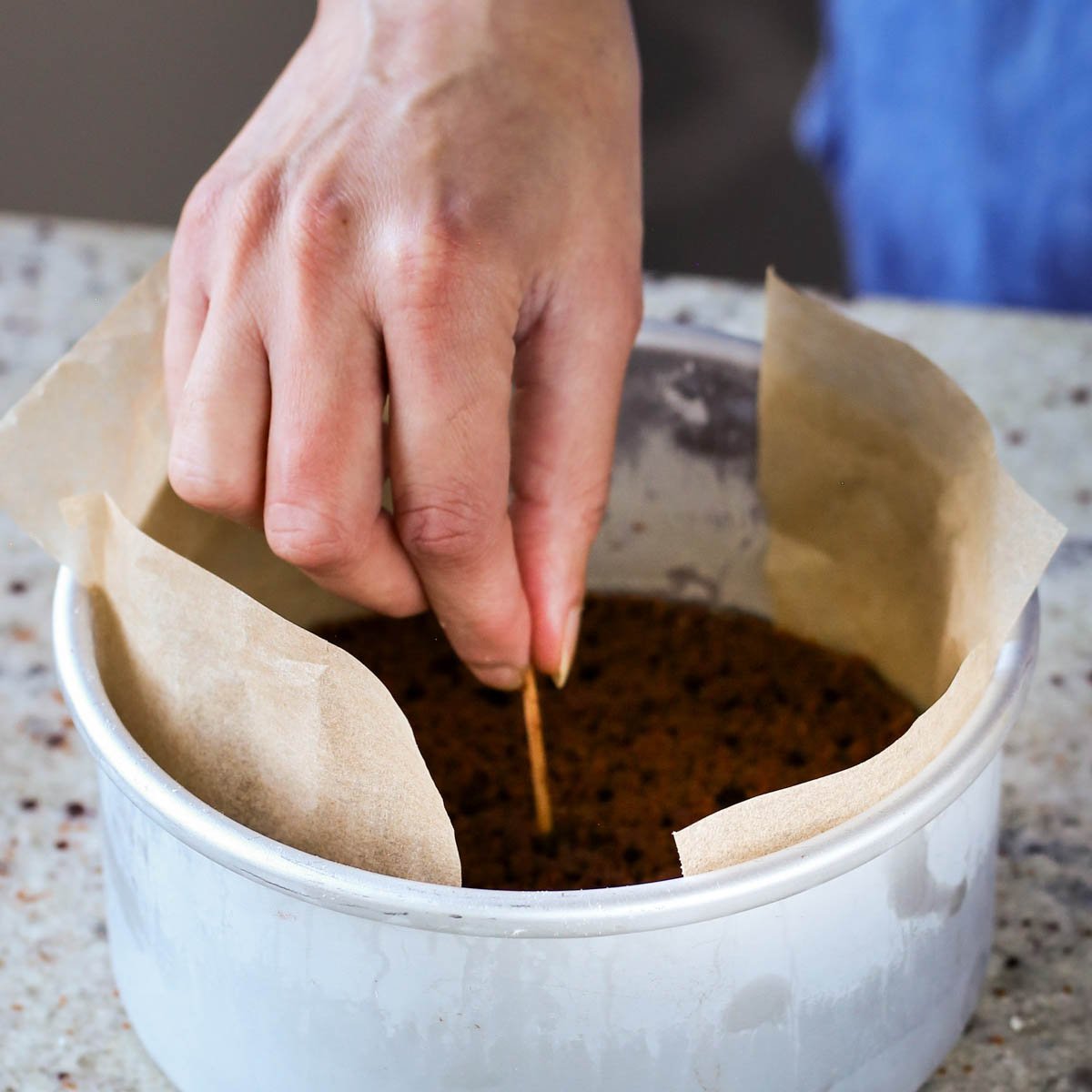 poking holes in the cake with a toothpick