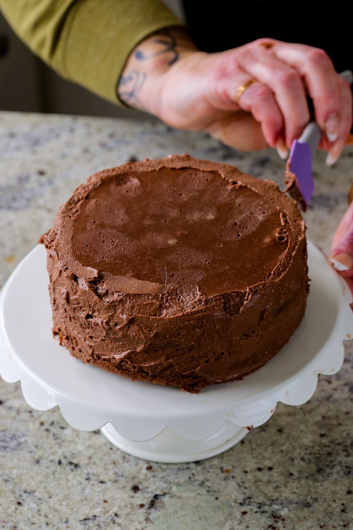 spreading the mocha mousse all over the cake