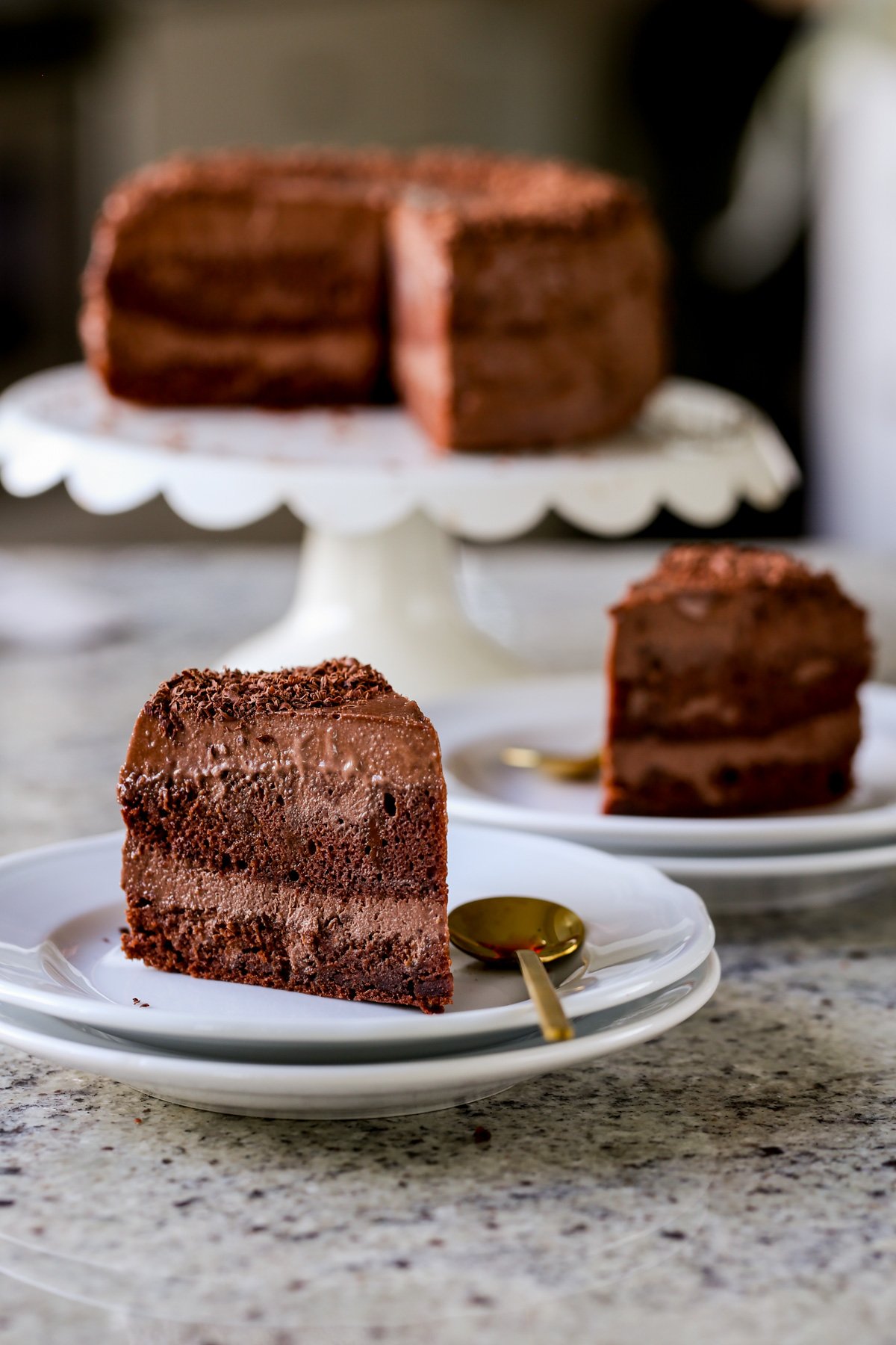 slices of mocha mousse cake with the whole cake in the background