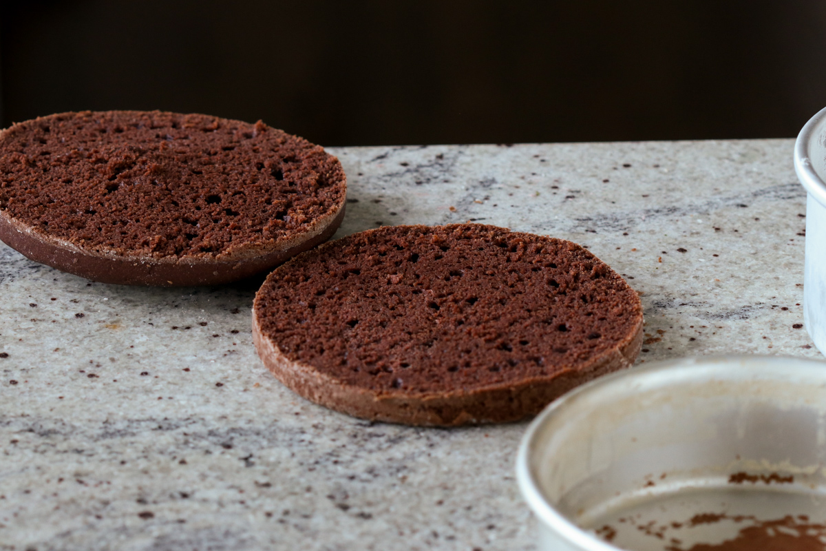 mocha cake after slicing in half and poking holes with a toothpick