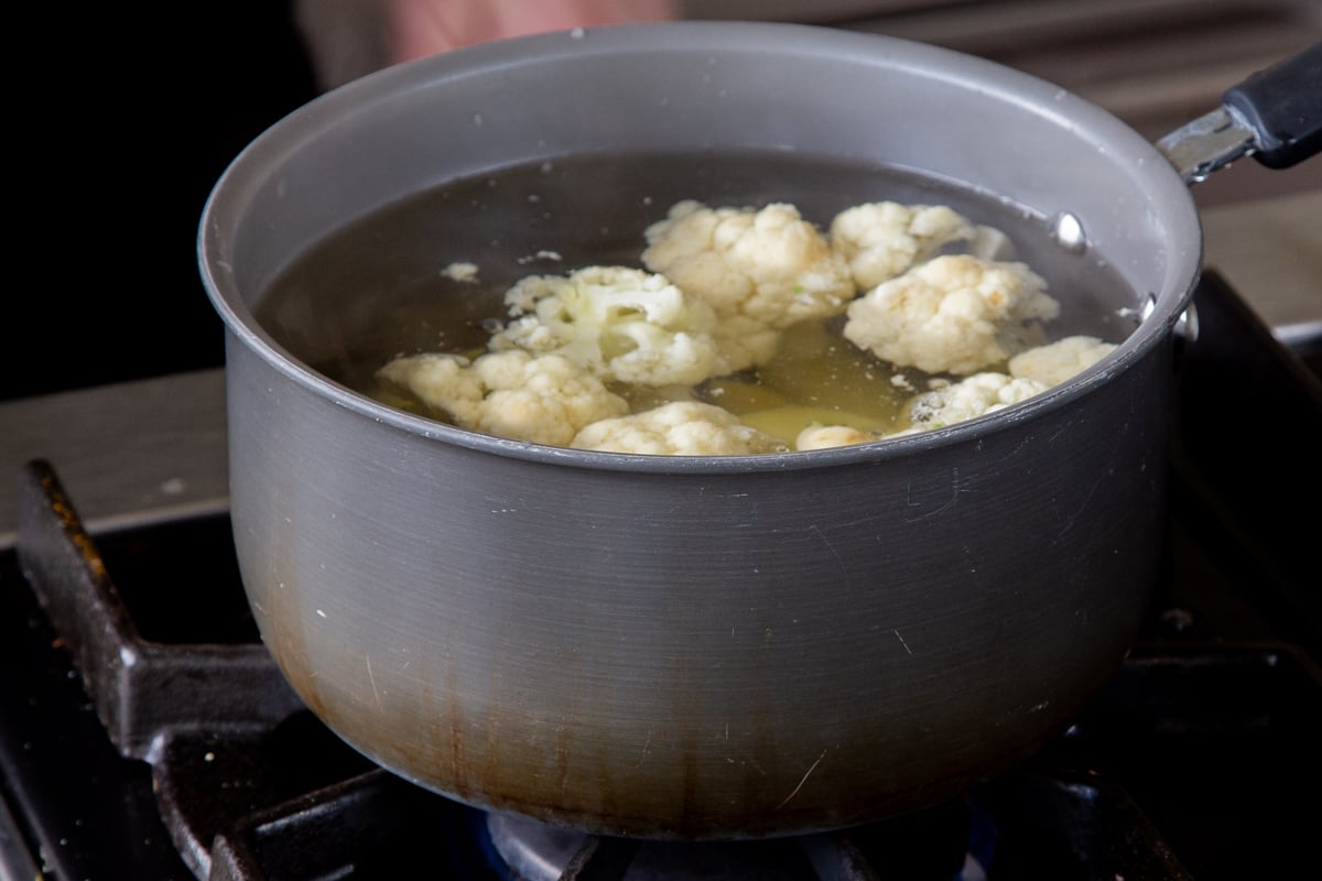 cauliflower and potatoes in a pan on the stovetop