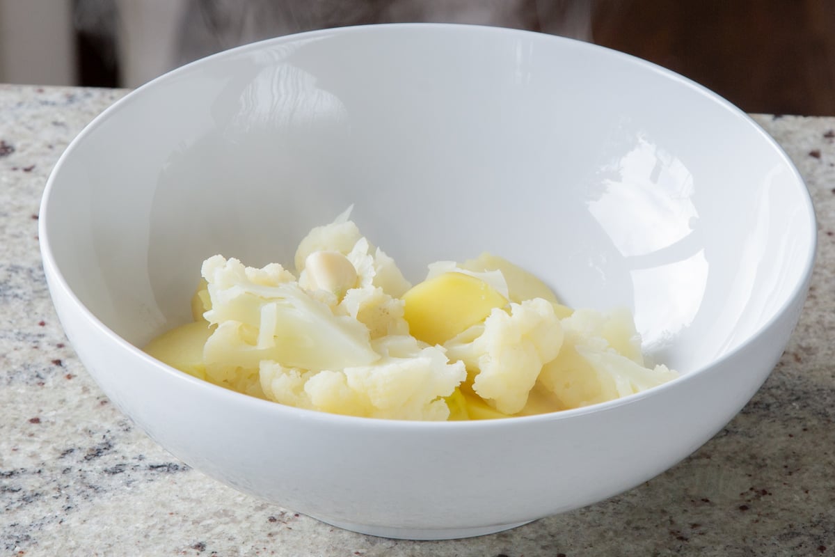 potato-cauliflower mash ingredients in a bowl
