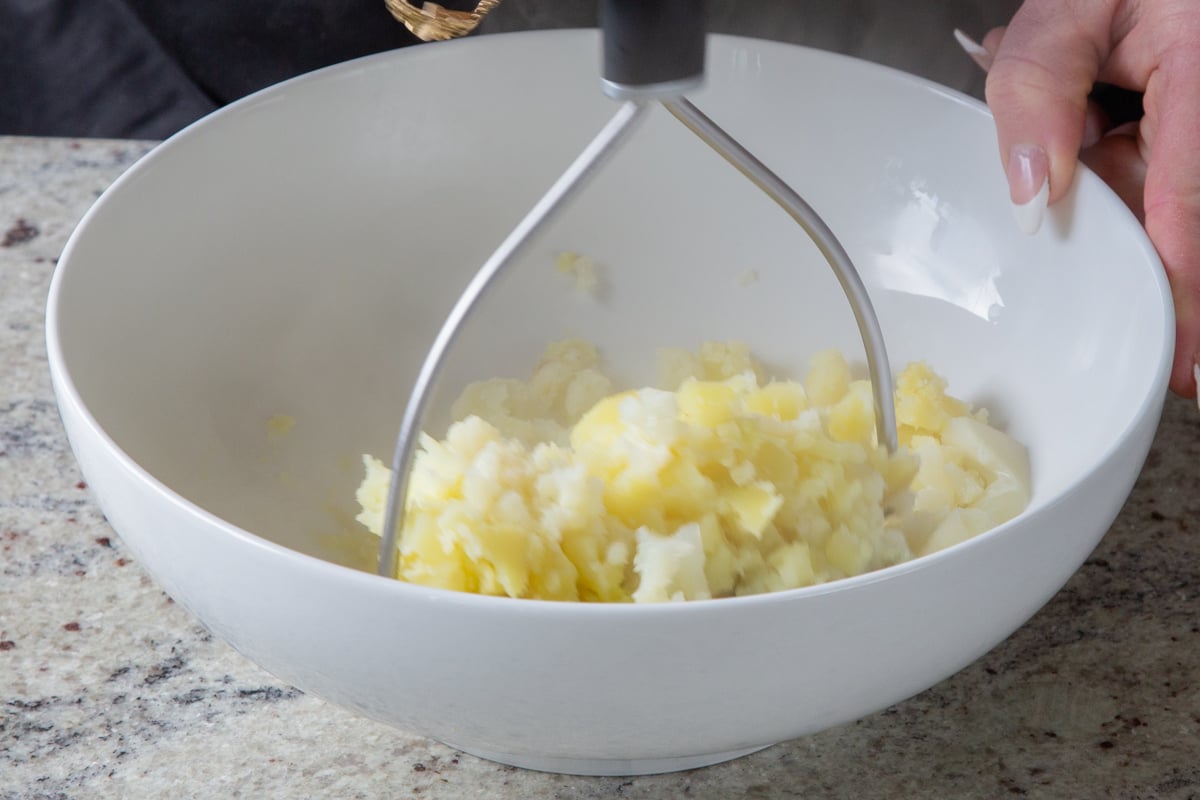 mashing the potatoes and cauliflower