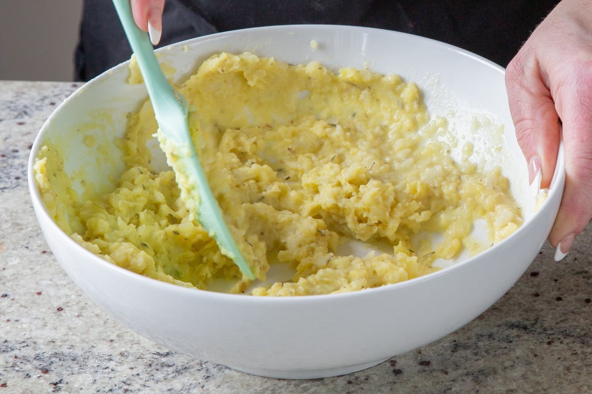 mashing the potatoes and cauliflower with the spices