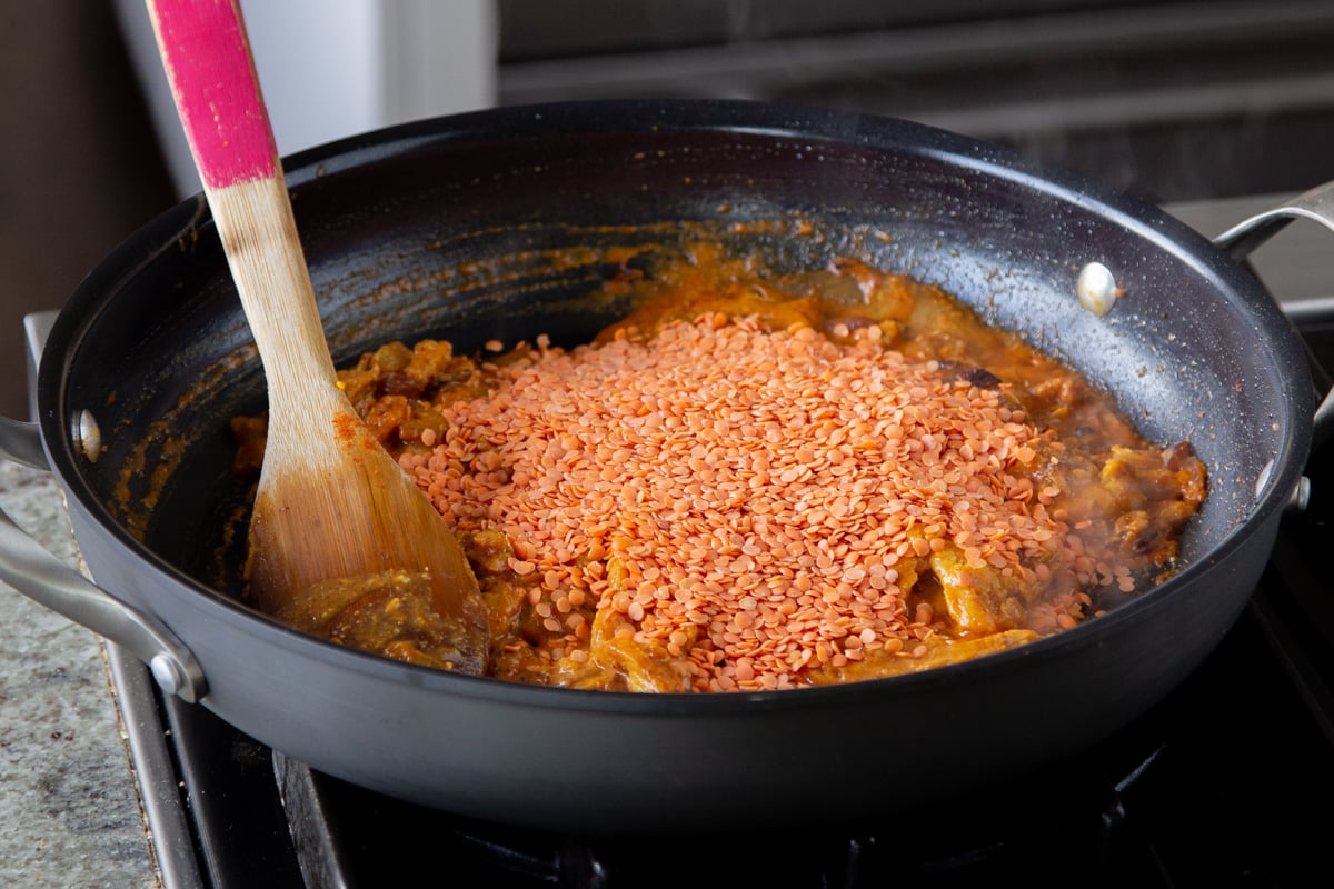 adding dry red lentils to the soy curl mixture