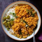 bowl of vegan dalcha with rice and veggies