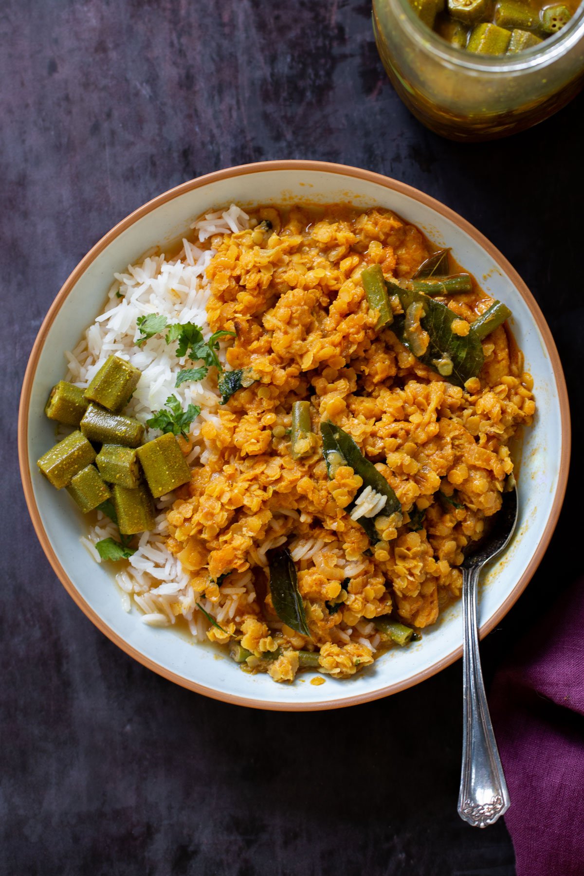 bowl of vegan dalcha  with rice and veggies