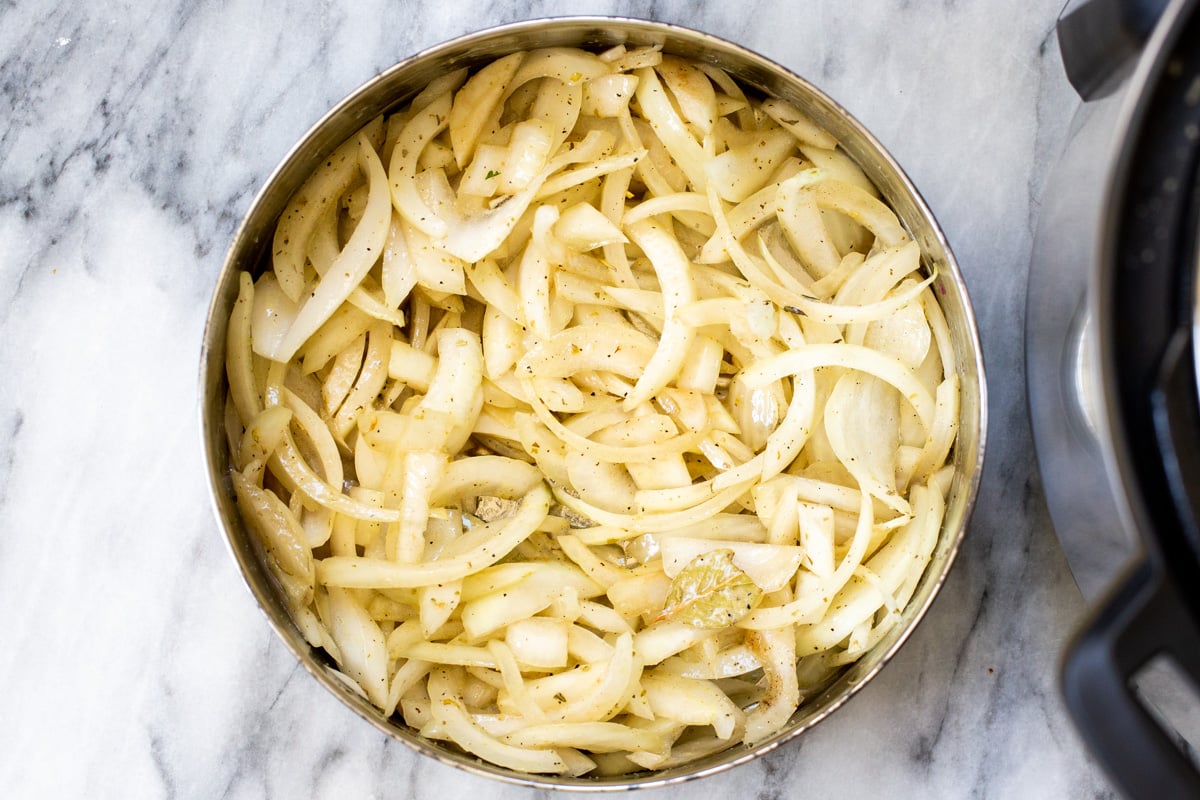 seasoned slices of onion in an Instant Pot