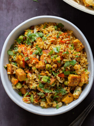 bowl of podi rice on the table with cilantro on top