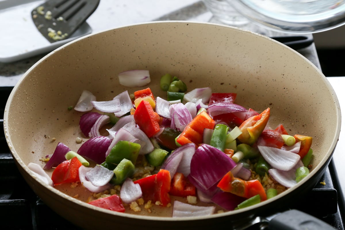 adding veggies to the pan