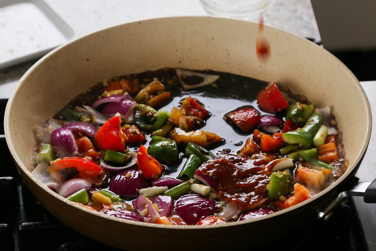 adding sauces to the pan