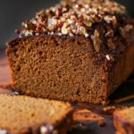 gingerbread cake on a cutting board with a slice cut out