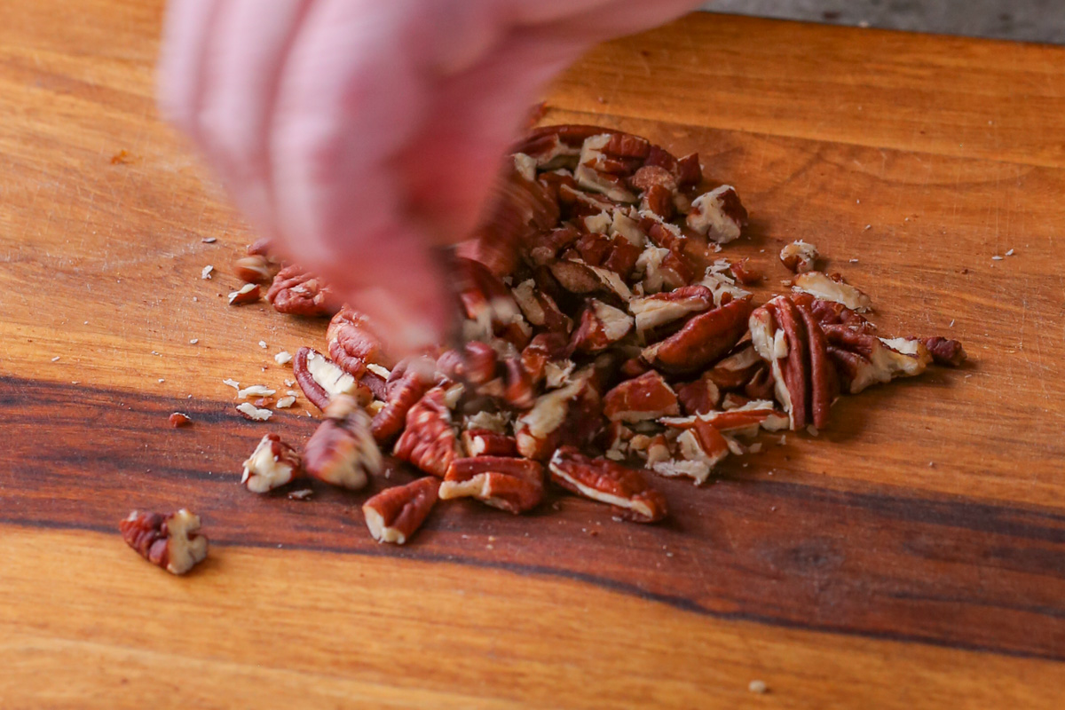 chopping pecans on a cutting board