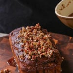 adding the ginger glaze to the vegan gingerbread cake