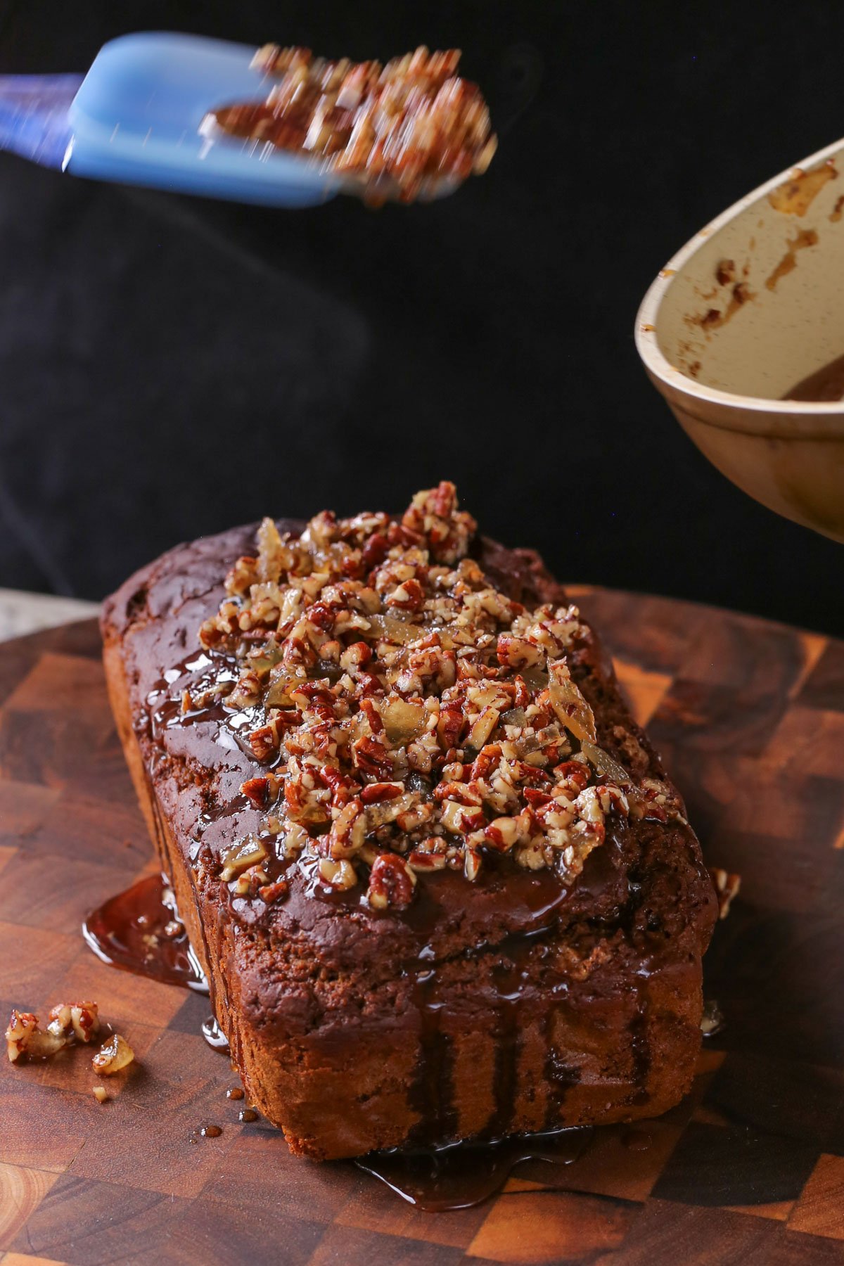 adding the ginger glaze to the vegan gingerbread cake