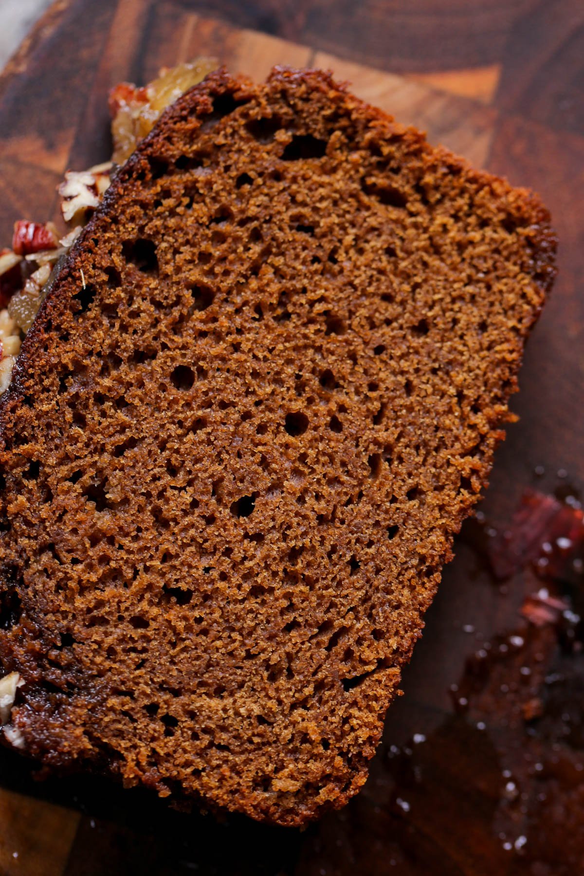 close-up of a slice of vegan gingerbread cake on a cutting board