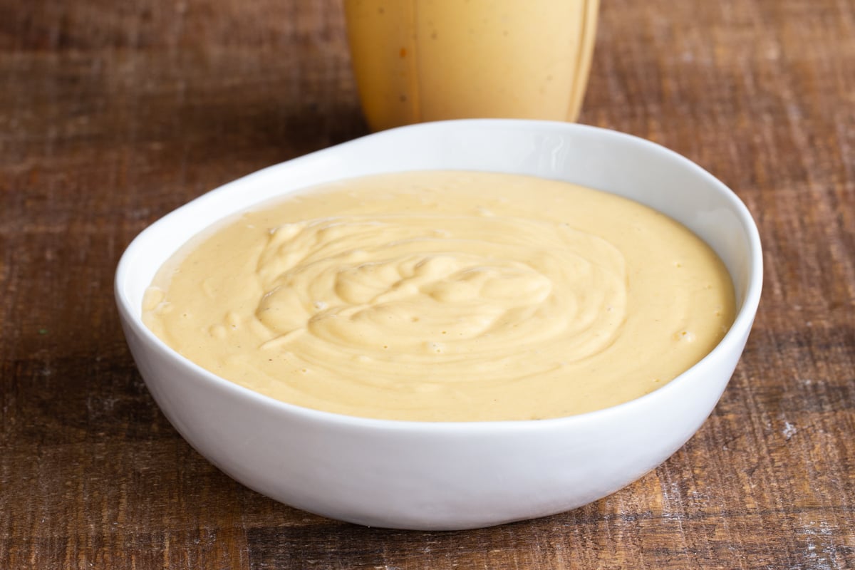 a small bowl filled with vegan cheese sauce 