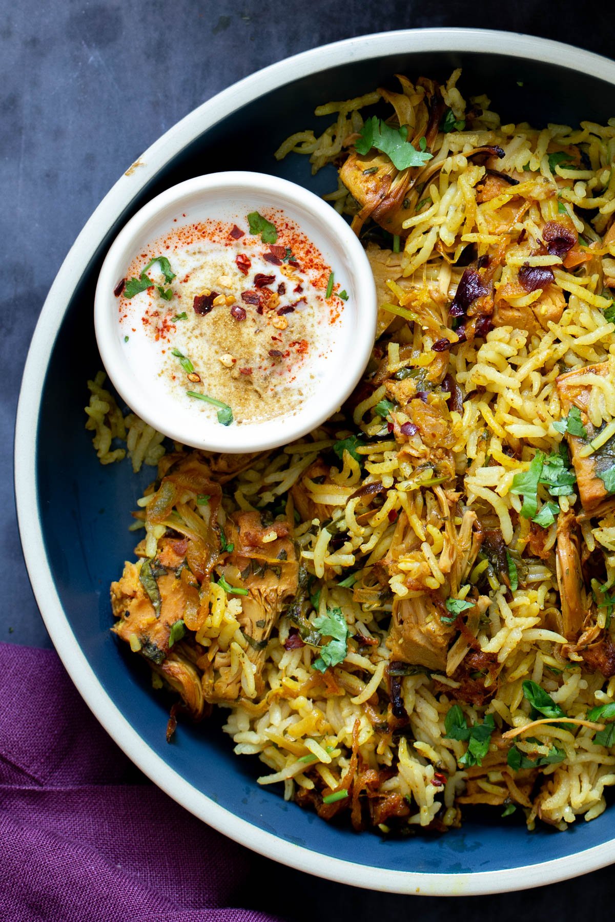 bowl of jackfruit biryani with raita