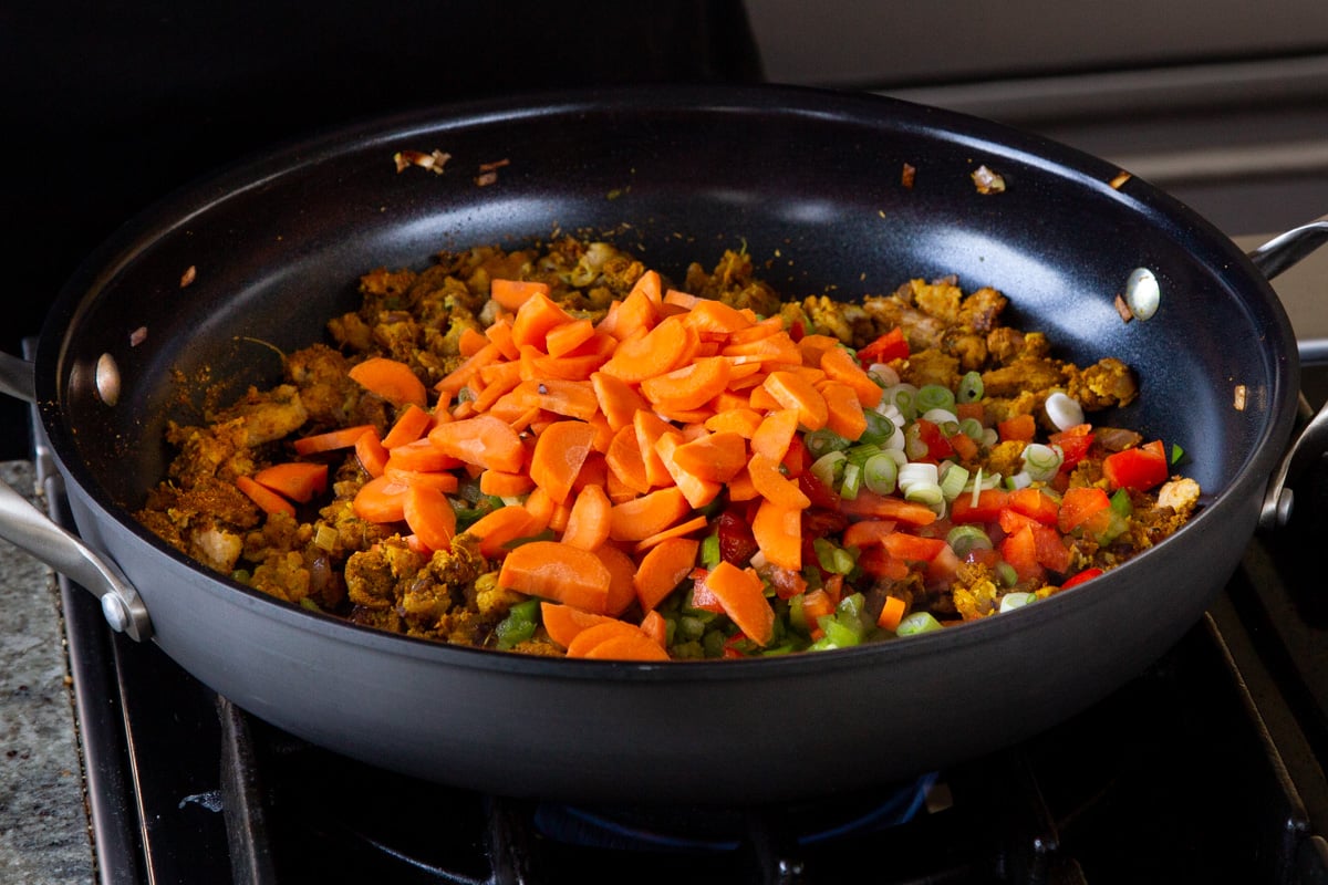 adding the carrots to the pan