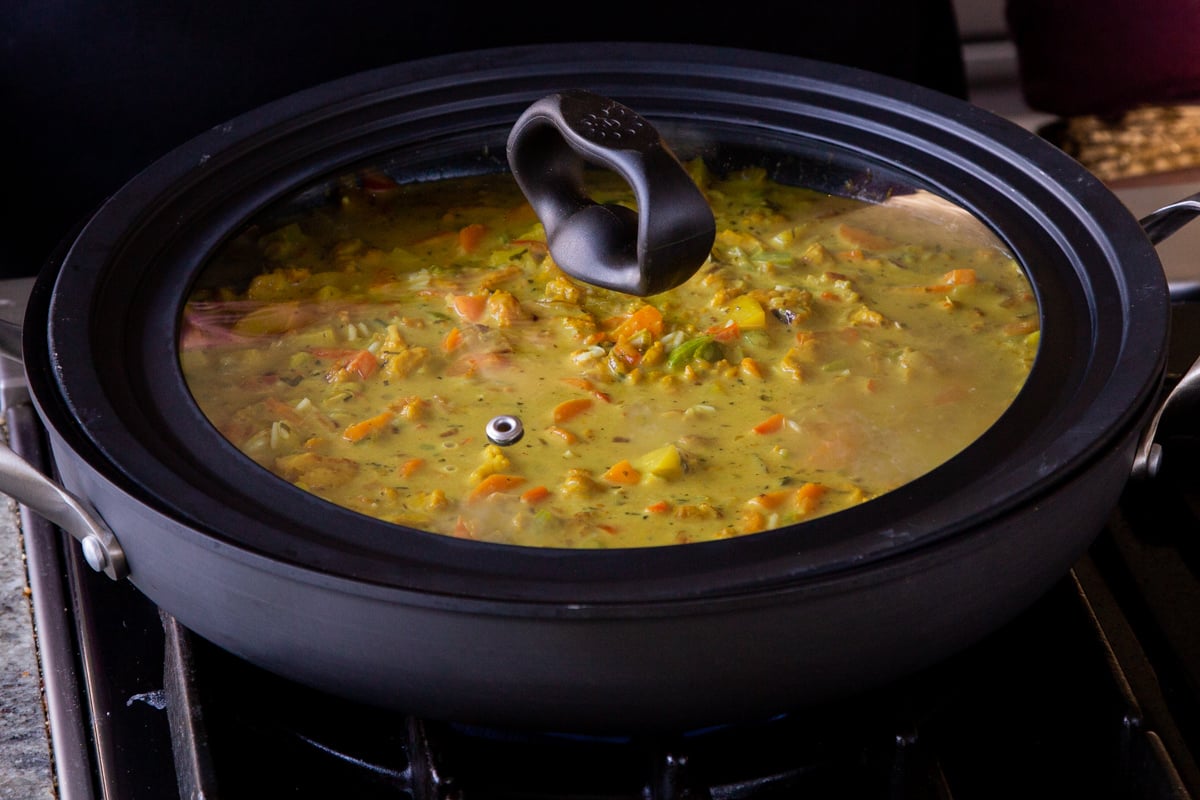 Jamaican curry rice in the pan with the lid on, before cooking