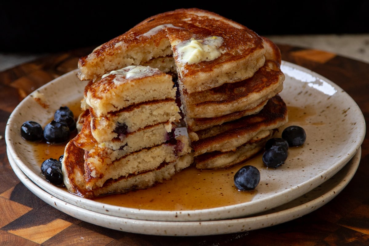 stack of gluten-free lemon blueberry pancakes with a bite cut out