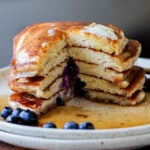 stack of gluten-free lemon blueberry pancakes with a bite cut out