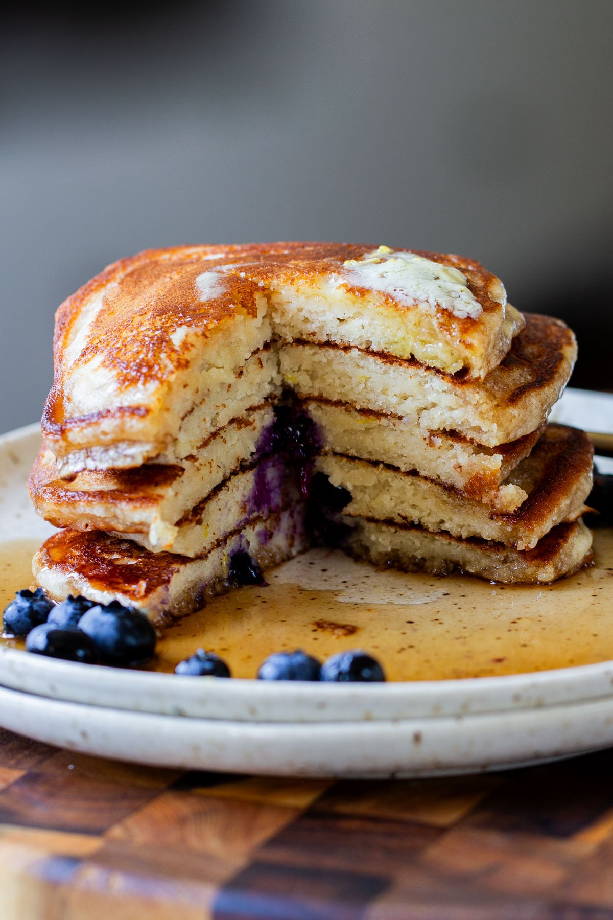 stack of gluten-free lemon blueberry pancakes with a bite cut out