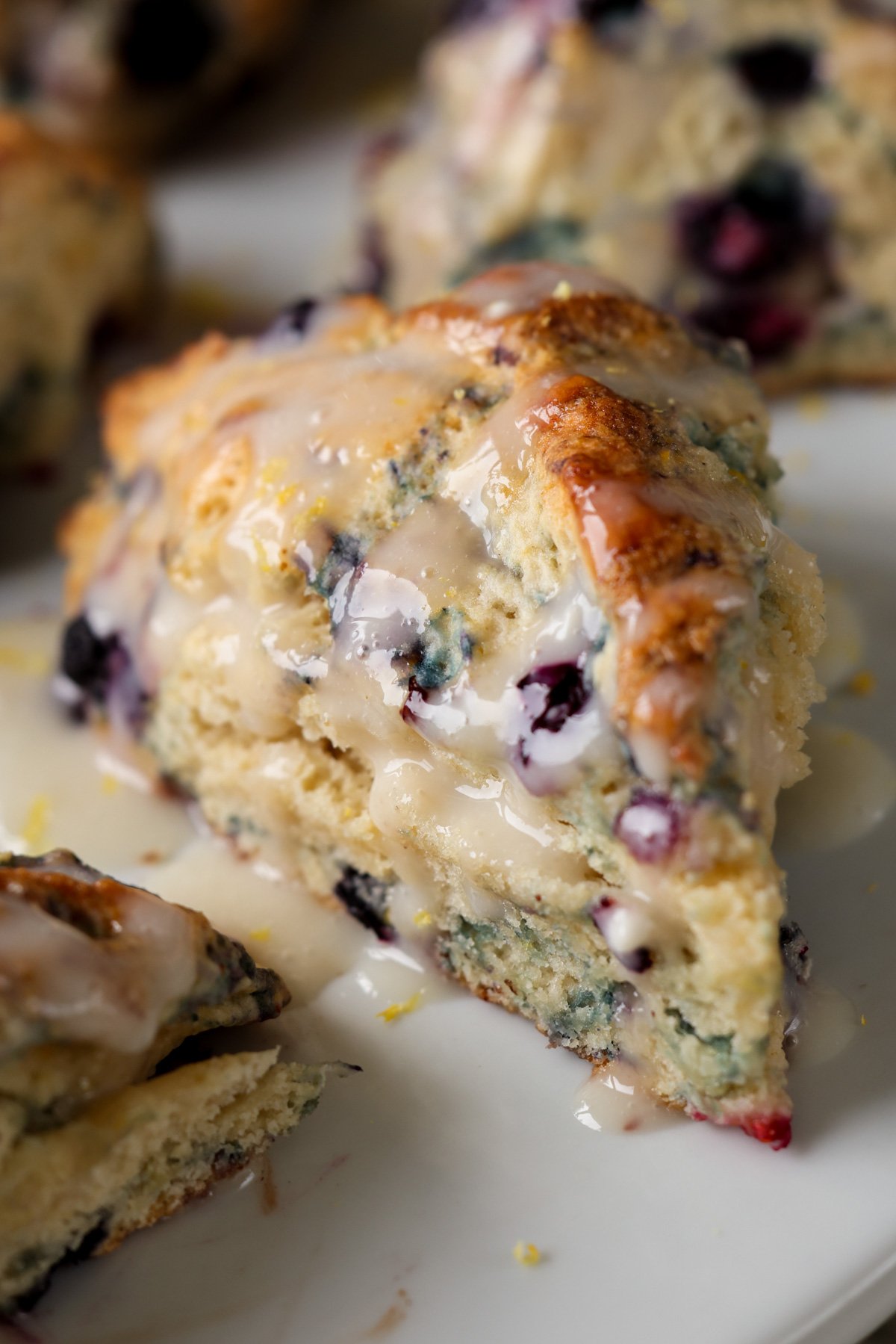 close-up of a glazed lemon blueberry scone