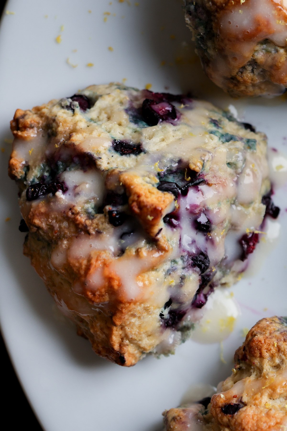 close-up of a glazed lemon blueberry scone