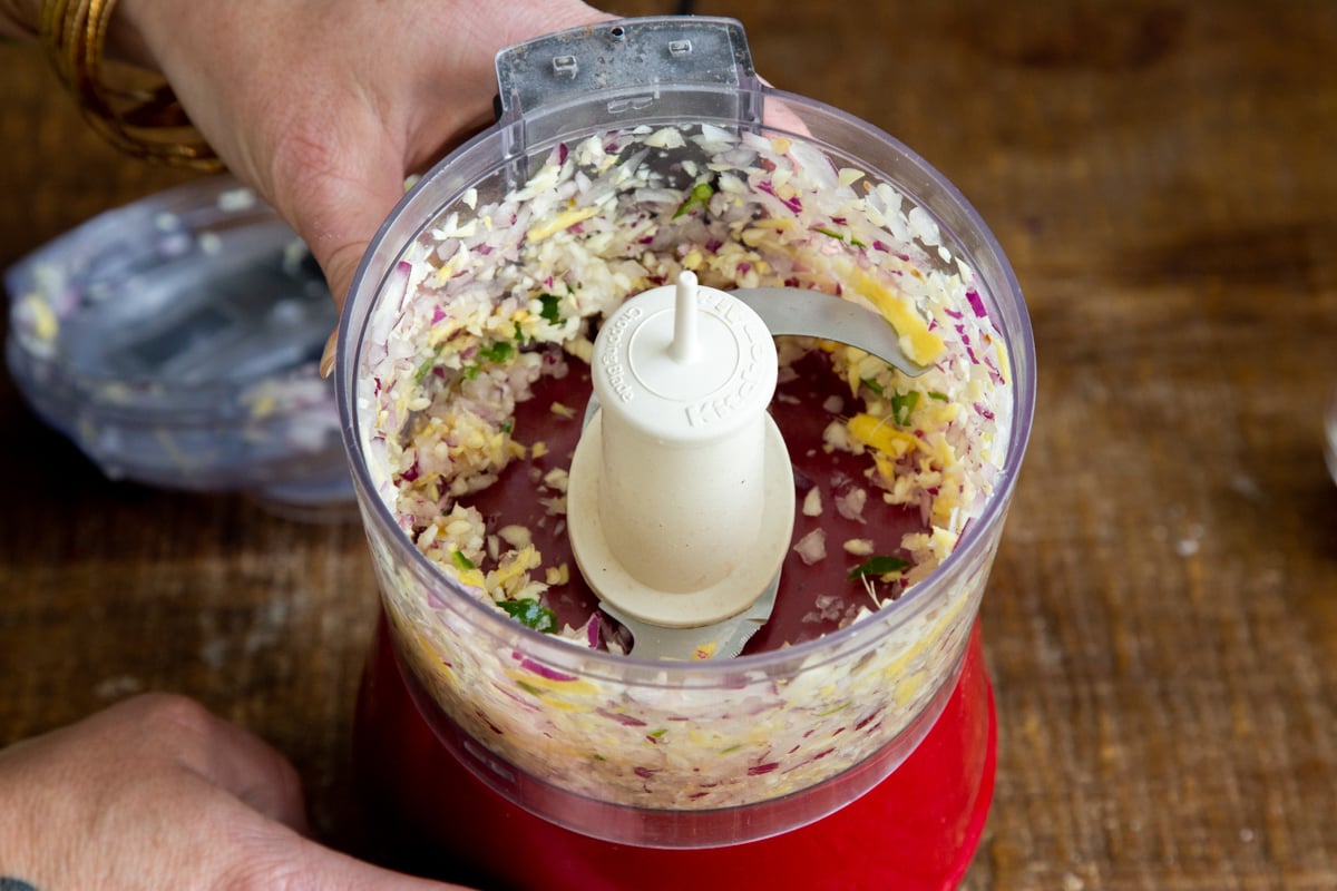 ginger, garlic and chili being processed in a food processor