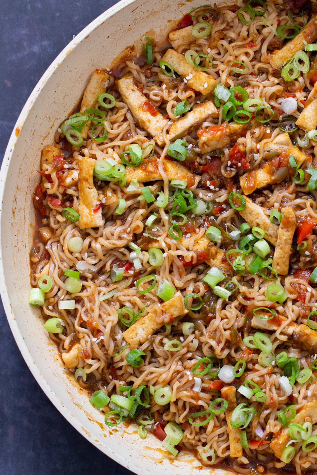 close-up of Indo chinese manchurian noodles sprinkled with green onions