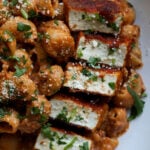 close-up of marry me pasta on a white plate with seared tofu pieces