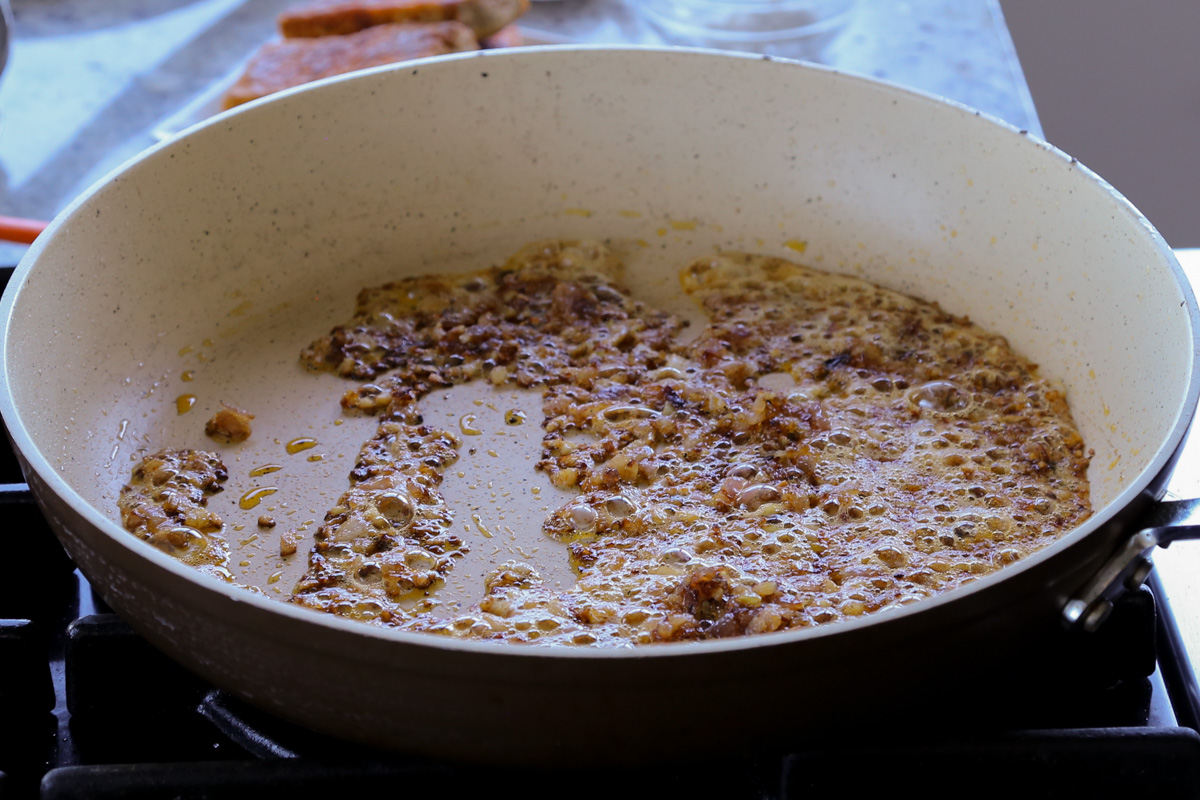 adding sun dried tomato to the pan with the onion