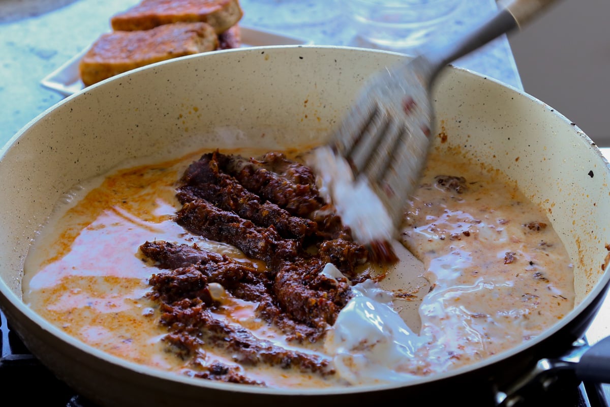 mixing the tomato paste mixture with a little non-dairy milk