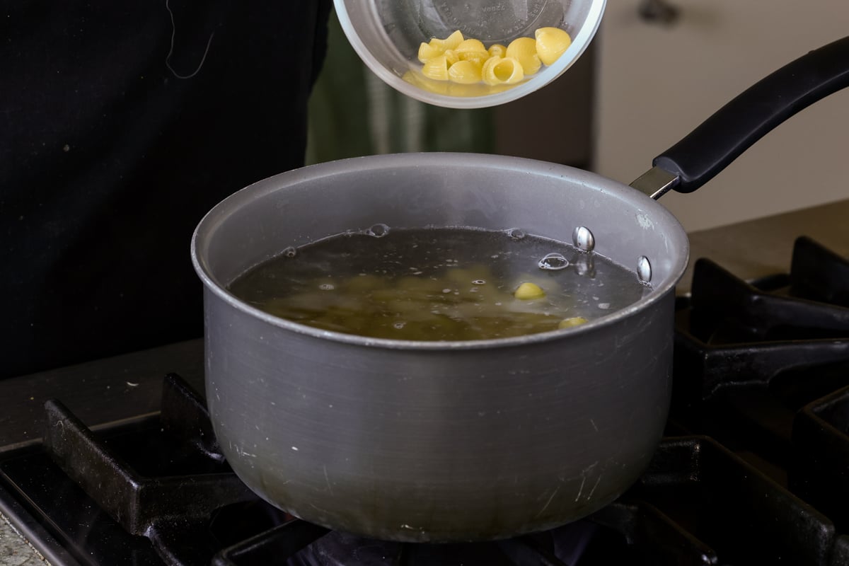 adding pasta to boiling water