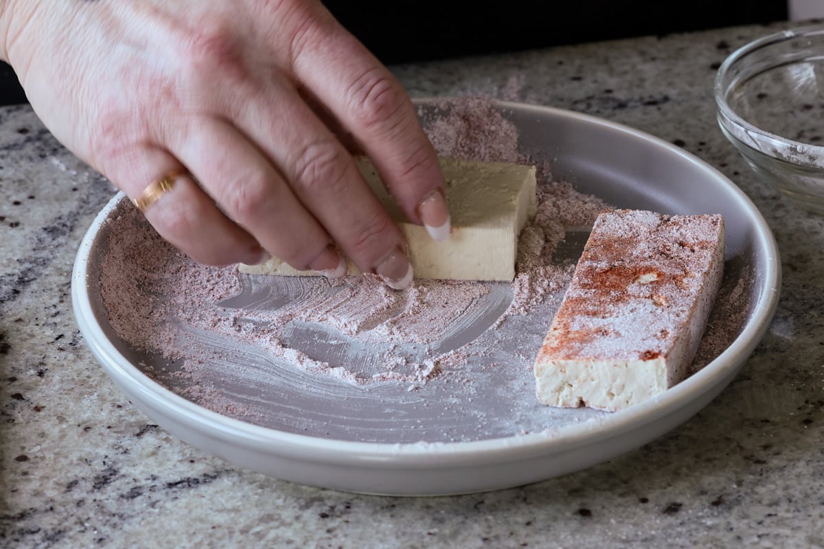 coating the tofu in the cornstarch mixture