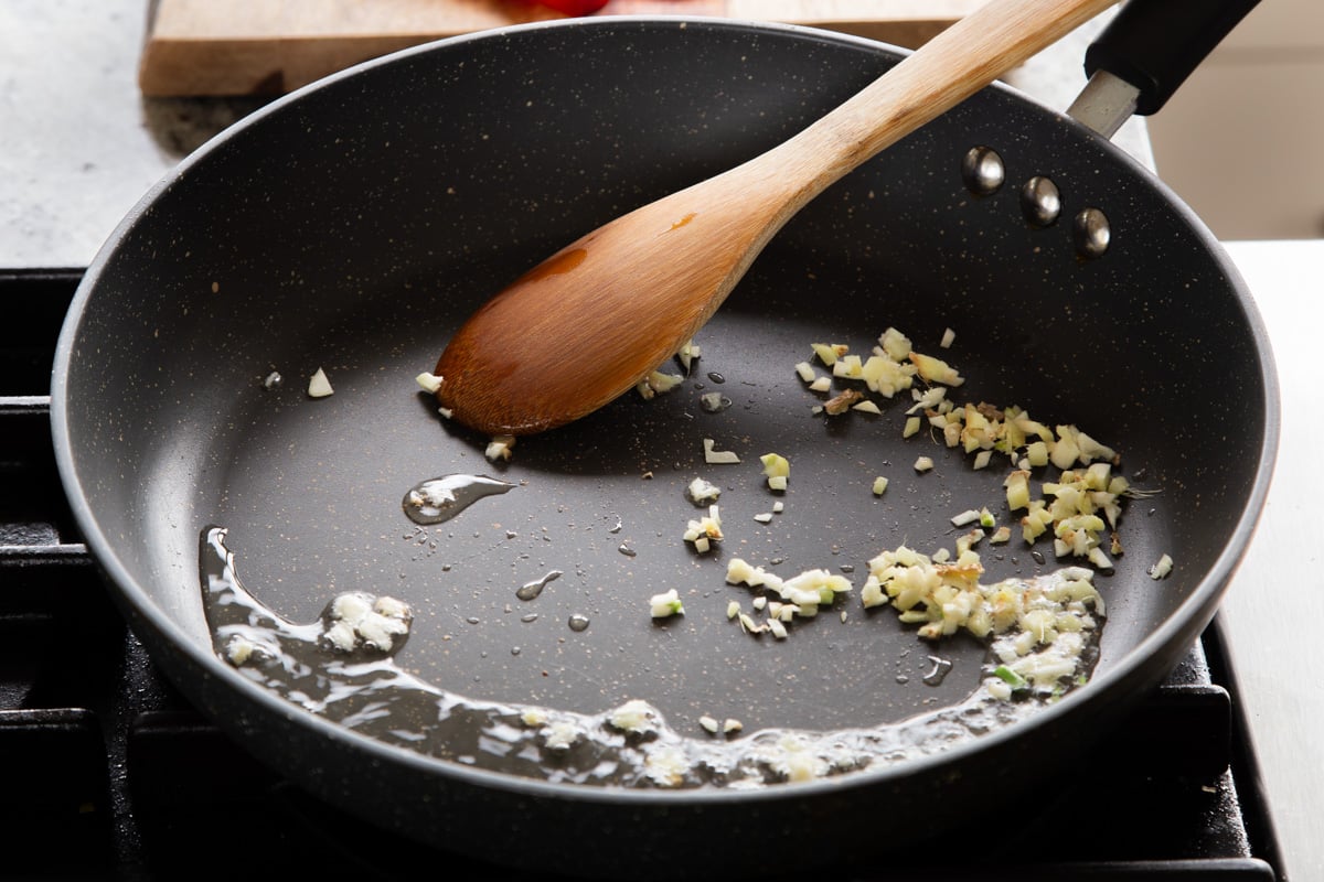 cooking the garlic and ginger in the pan