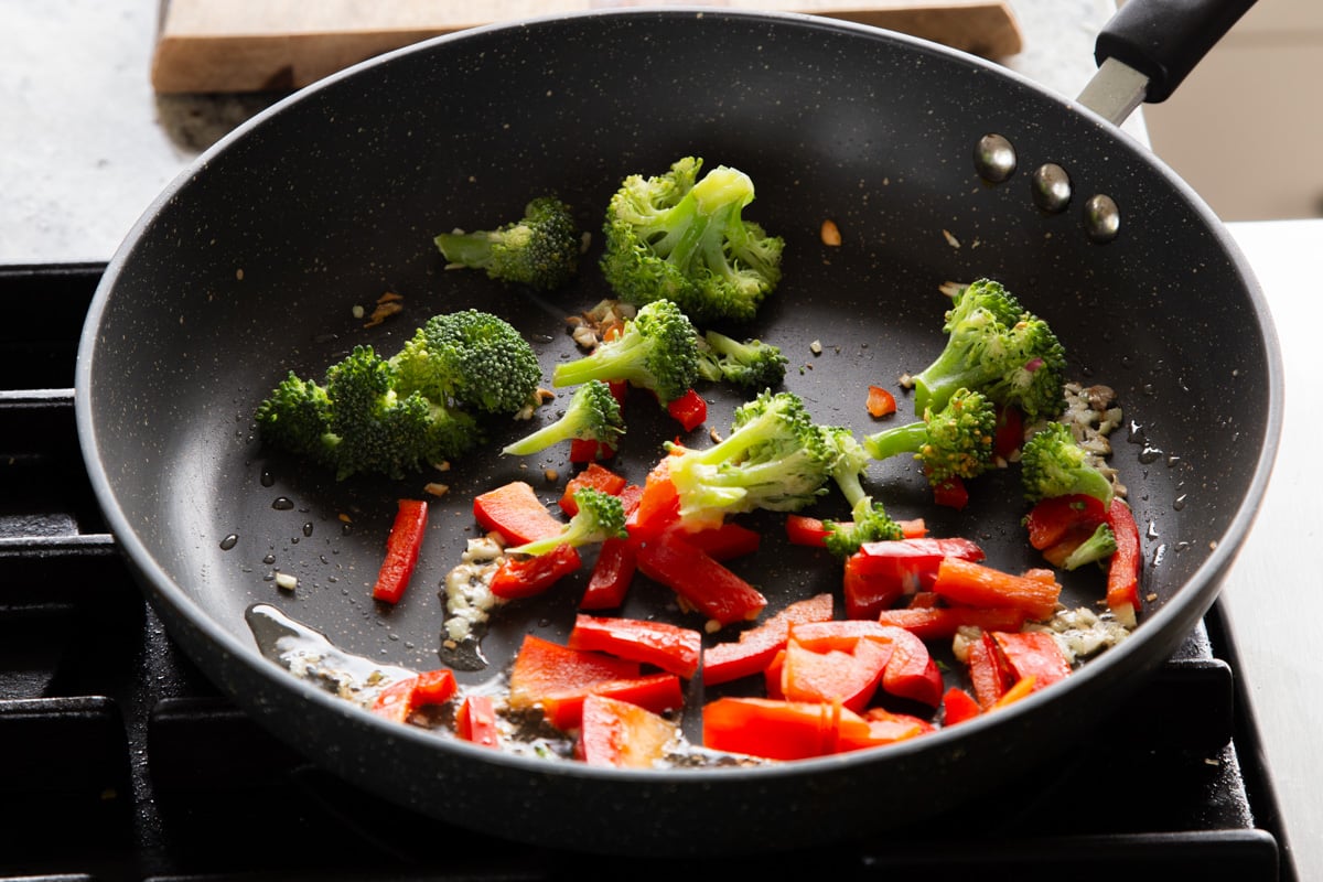 adding the veggies to the pan